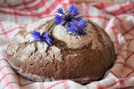 cornflowers decorating a loaf of bread